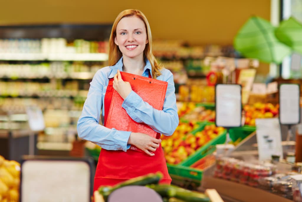 Smiling saleswoman in supermarket