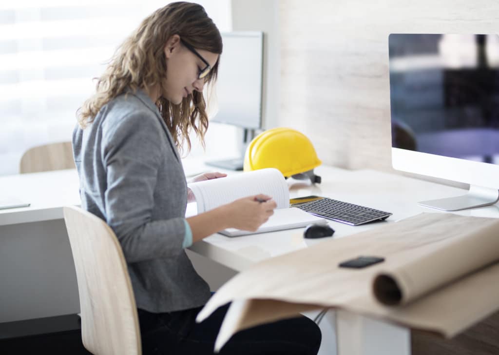 Female architect writing down notes