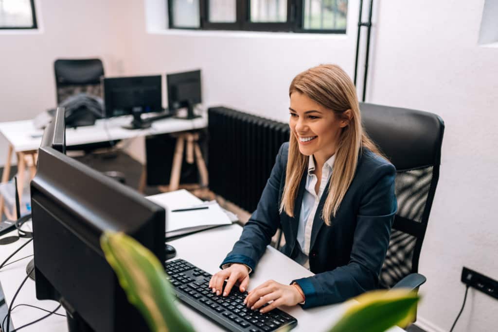 Portrait of a happy businesswoman working in the office.