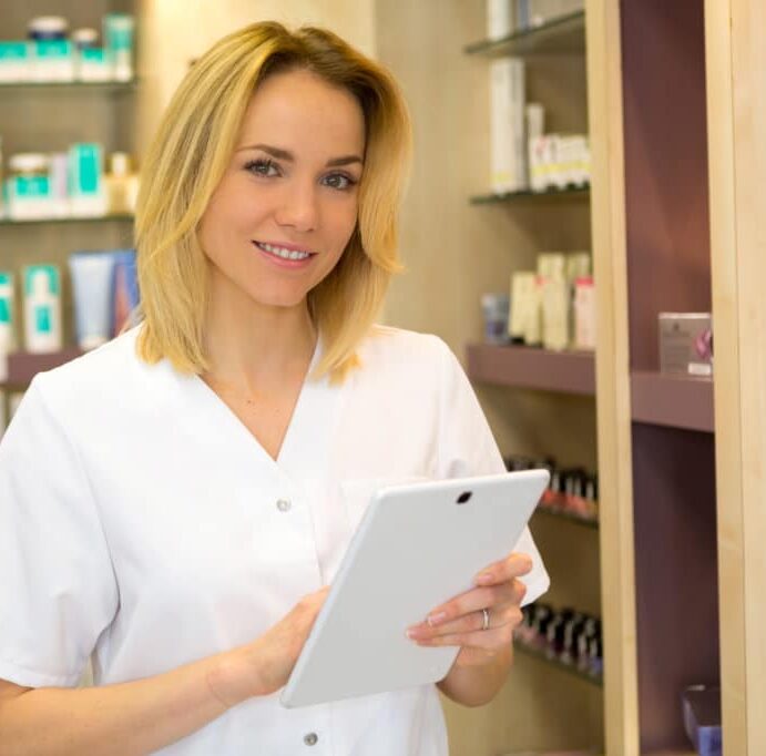 Young attractive beautician working in a beauty salon