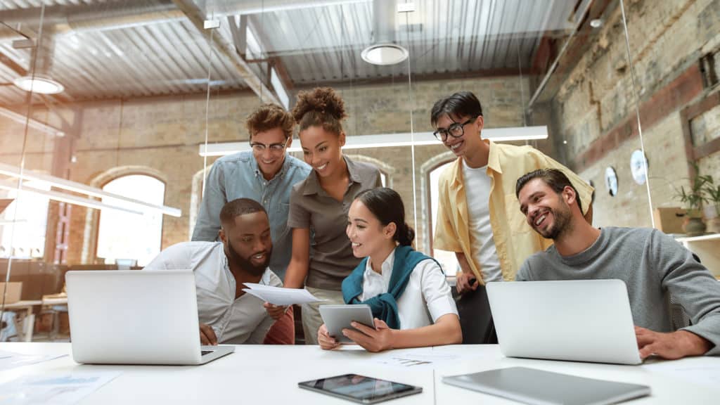 We have great results! Group of young cheerful business people in casual wear working together on new project while sitting in the creative office